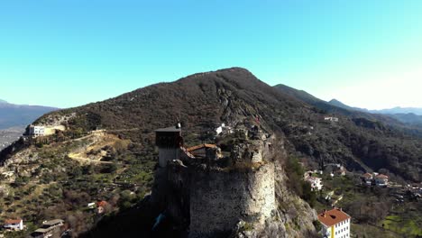 Old-fortress-with-stone-walls-and-tower-built-over-rocky-hill-in-Petrela,-Albania