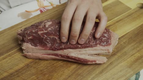 Cutting-off-extra-fat-from-meat-steak-on-the-cutting-board
