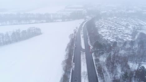 Aerial-View-of-Cold-Snowy-Winter-Landscape,-Dense-Fog-Above-Highway-Near-Bochum,-Germany