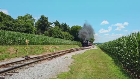 An-Antique-Restored-Steam-Engine-and-Passenger-Coaches-Traveling-thru-the-Countryside-and-Corn-Fields