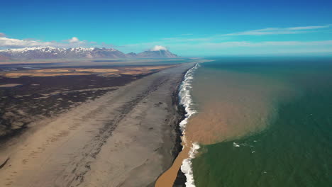 Aerial-View-Of-River-Mouth-On-The-Beach-In-South-Iceland-Coast---aerial-pullback