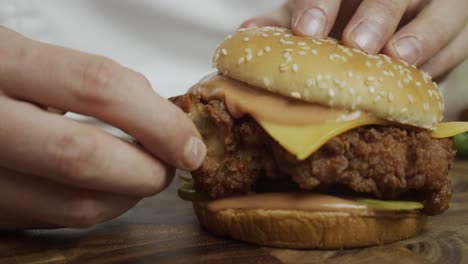 Chef-torn-away-crispy-crust-of-burger-chicken-meat