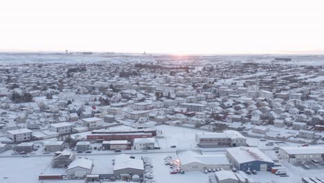 Stunning-bright-sundown-at-arctic-Iceland-town-of-Reykjanesbær,-aerial