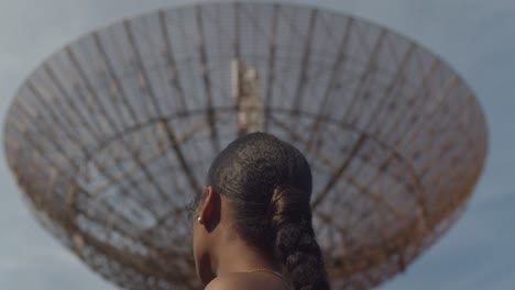 Amazing-closeup-of-a-model-looking-at-a-radar-tracking-station-in-the-distance