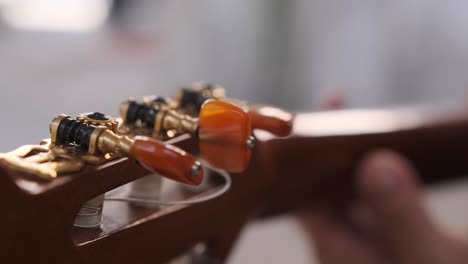 Unique-view-of-the-tuning-keys-on-a-guitar-as-a-musician-plays