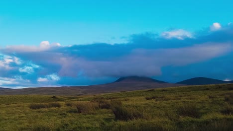Time-lapse-of-vibrant-landscape-with-hills-and-flying-cloudscape-at-blue-sky