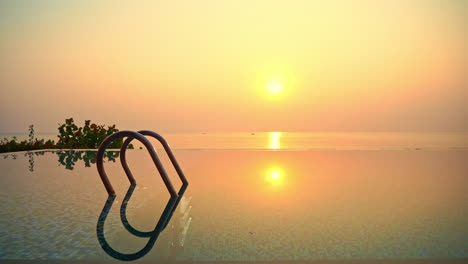 Stunning-Seascape-Golden-Sunset-Reflection-in-Infinity-Swimming-Pool