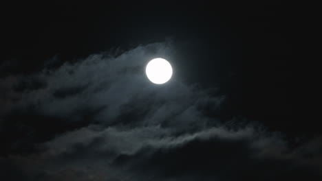 Clouds-Passing-In-Front-Of-The-Moon-In-The-Night-Sky---low-angle-shot