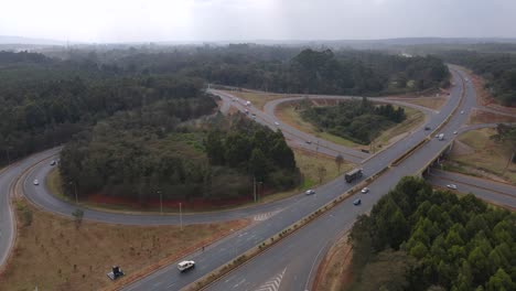 Traffic-on-modern-freeway-junction-on-Nairobi-southern-bypass-Kenya,-Aerial-view