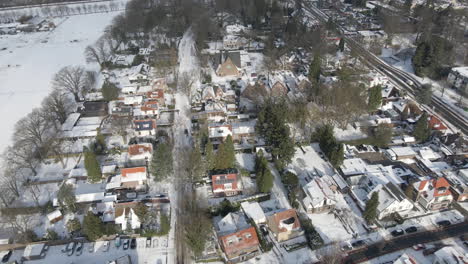 Aerial-of-small-town-with-church-in-the-background-in-winter