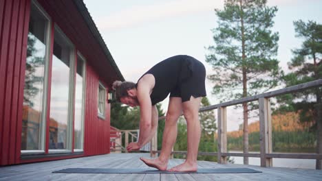 Man-Doing-Forward-Bend-Stretching-On-Yoga-Mat