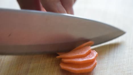 Close-up-of-Woman's-hand-cutting-a-carrot.Side-frame