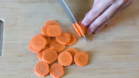 Close-up-of-Woman's-hand-cutting-a-carrot.Top-view