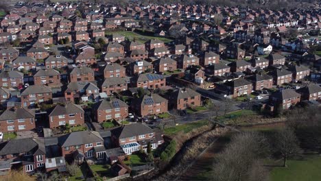 Typical-Suburban-Kent-village-residential-neighbourhood-property-rooftops-aerial-view-dolly-left