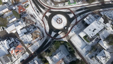 Aerial-of-traffic-driving-around-roundabout-in-winter