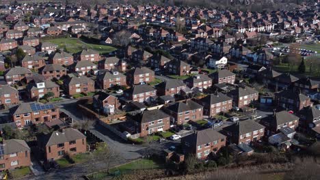 Typical-Suburban-village-residential-Manchester-neighbourhood-property-rooftops-aerial-view-dolly-left