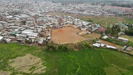 poor-settlement-of-Kibera-largest-slums-in-Nairobi-Kenya,-poor-house-settlement-in-the-biggest-slums-of-Africa,-slums-of-kibera-largest-in-Kenya,-Children-paying-football-in-Slums-of-Kibera-Nairobi