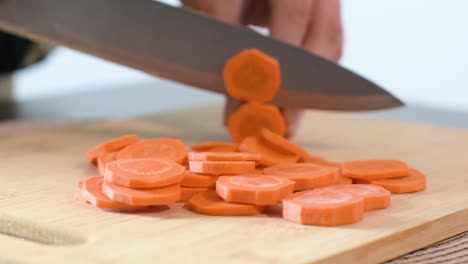 Close-up-of-Woman's-hand-cutting-a-carrot