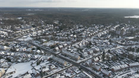 Aerial-overview-of-small-rural-town-in-winter---drone-flying-backwards