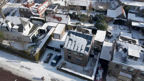 Jib-up-of-solar-panels-on-house-rooftop-covered-in-snow