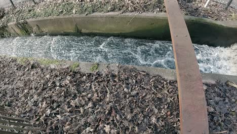 Slow-motion-river-overflow-trench-channel-water-overflowing-dam-narrow-feed