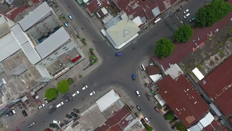 Road-intersection-in-Mataram-City,-Indonesia,-aerial-top-view