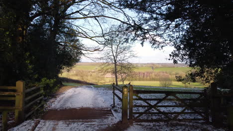 A-farm-track-leading-through-a-farm-gate-opens-up-to-spectacular-views-of-the-Worcestershire-Countryside,-England,-UK-on-a-cold-winters-day