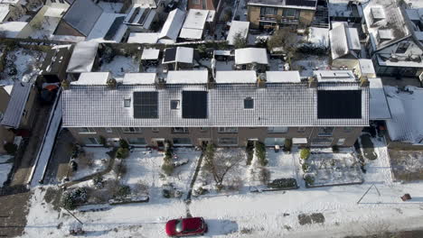 aerial-dolly-of-solar-panels-of-snow-covered-rooftops