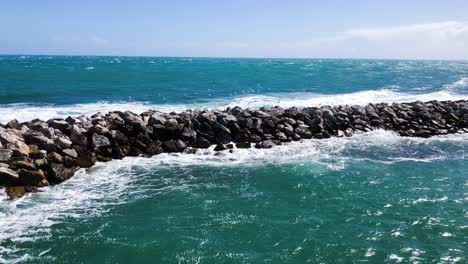 Breakwater-of-rocks-in-a-stormy-sea