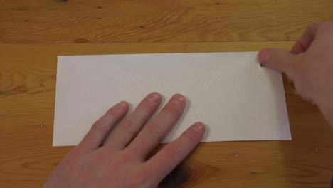Man-Places-Stamp-on-Blank-Envelope,-First-Person-Point-of-View