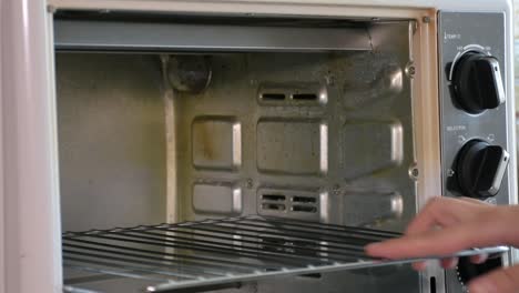 Inserting-the-cake-tray-into-the-oven