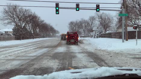 Driving-behind-snow-plows-as-they-clean-the-roadway-on-a-cold-snowy-day