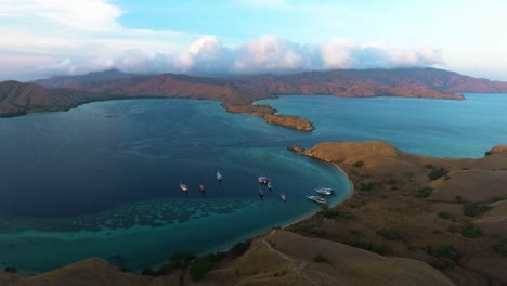 aerial-view-of-komodo-national-park-flores-island-indonesia,-travel-touristic-destination-cruise-boat-park-in-the-bay-pristine-clear-ocean-water-gorgeous-archipelago-holiday-paradise