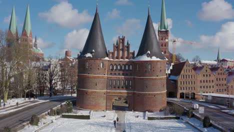 Aerial-view-of-the-Holsten-Gate-in-Lübeck-after-snowing