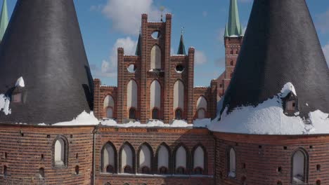 Aerial-view-of-the-Holsten-Gate-in-Lübeck-after-snowing