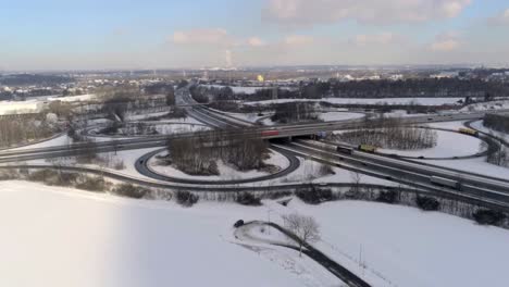 Aerial-View-of-Traffic-on-A40-and-A45-Autobahn-Intersection-and-Winter-Landscape-Outside-Dortmund,-Germany,-Drone-Shot