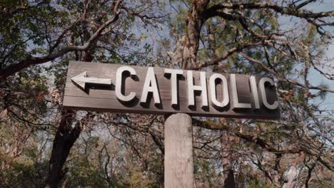 Wooden-Cemetery-Sign-Pointing-To-Catholic-Section-of-Graveyard---4K