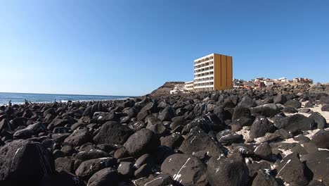 Low-angle,-view-of-a-resort-hotel-on-the-rocky-volcanic-beach-of-Rocky-Point,-Mexico