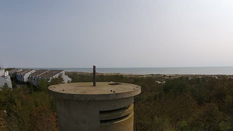 Drone-shot-rises-above-World-War-II-watchtower-to-view-of-Atlantic-Ocean