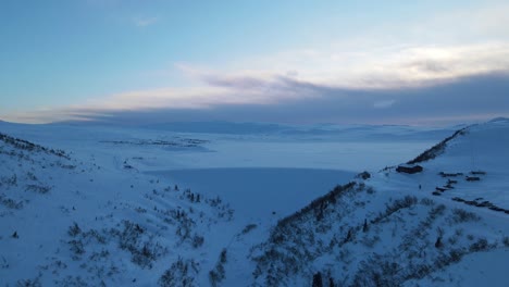 Cierre-De-Imágenes-De-Drones-De-Una-Enorme-Represa-Al-Lado-De-Un-Lago-De-Montaña-Congelado-En-El-Sur-De-Noruega