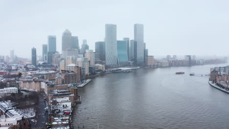 Stationary-drone-shot-of-Canary-wharf-skyscrapers-in-the-snow