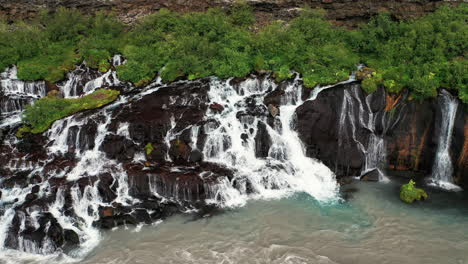 Hraunfossar-Waterfalls-Cascading-To-Hvita-From-Ledges-Of-moss-covered-Rocks-In-West-Iceland