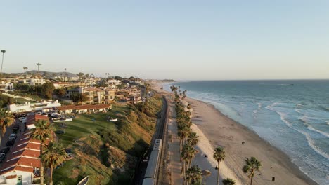 Palm-Trees-Lined-At-San-Clemente-Pier-City-Beach-In-San-Clemente,-California-On-A-Sunset