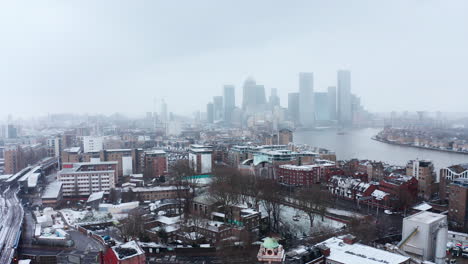 Drone-shot-in-snow-towards-Canary-Wharf-from-Limehouse-London