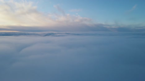 Drone-footage-above-the-clouds-at-sunset