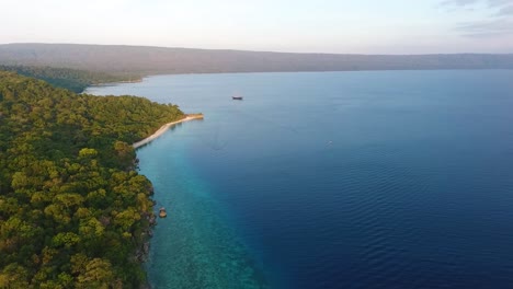 aerial-footage-of-Moyo-Island,-Sumbawa,-Indonesia-travel-destination-tropical-paradise-with-ocean-sand-beach-and-wild-green-tree-jungle-vegetation
