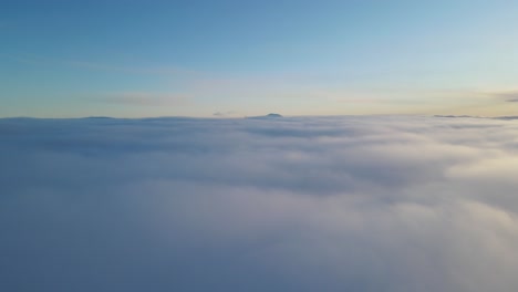 Flying-over-clouds-at-sunset-time