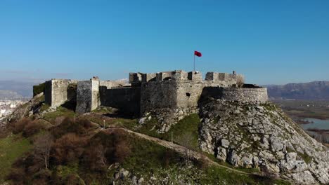 Epic-castle-of-Rozafa-with-stone-walls-on-the-top-of-the-hill-surrounded-by-mountains-in-Albania