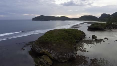 aerial-seascape-view-at-sunset-of-wild-lonely-beach-archipelago-paradise-Rantung-Beach,-West-Sumbawa,-Indonesia