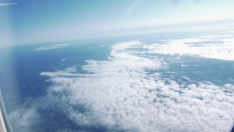 Beautiful-Cloud-Sky-View-From-Airplane-Window-Flying-From-Australia-To-Singapore---aerial,-POV